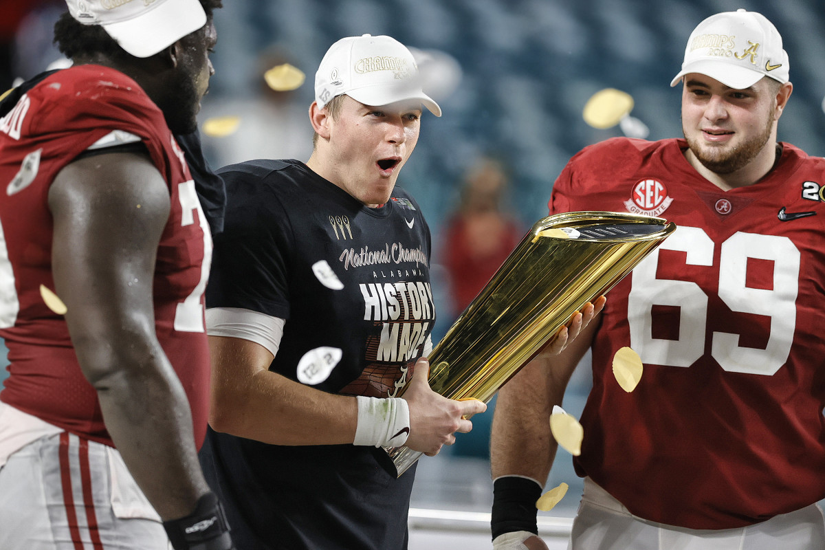 Alabama QB Mac Jones celebrates with the national championship trophy